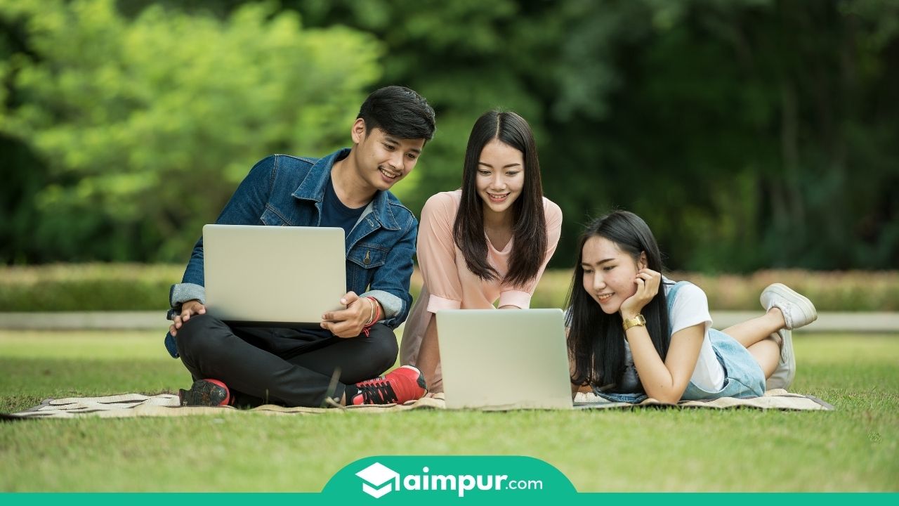 3 student with laptops and books in a ground- Best computer course after 12th